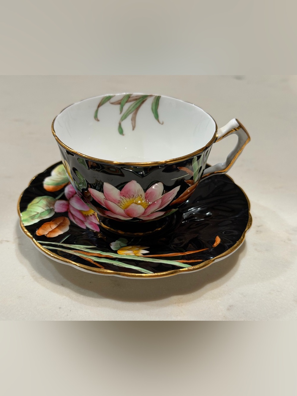 Floral Black Porcelain Teacup and Saucer with Gold Trim